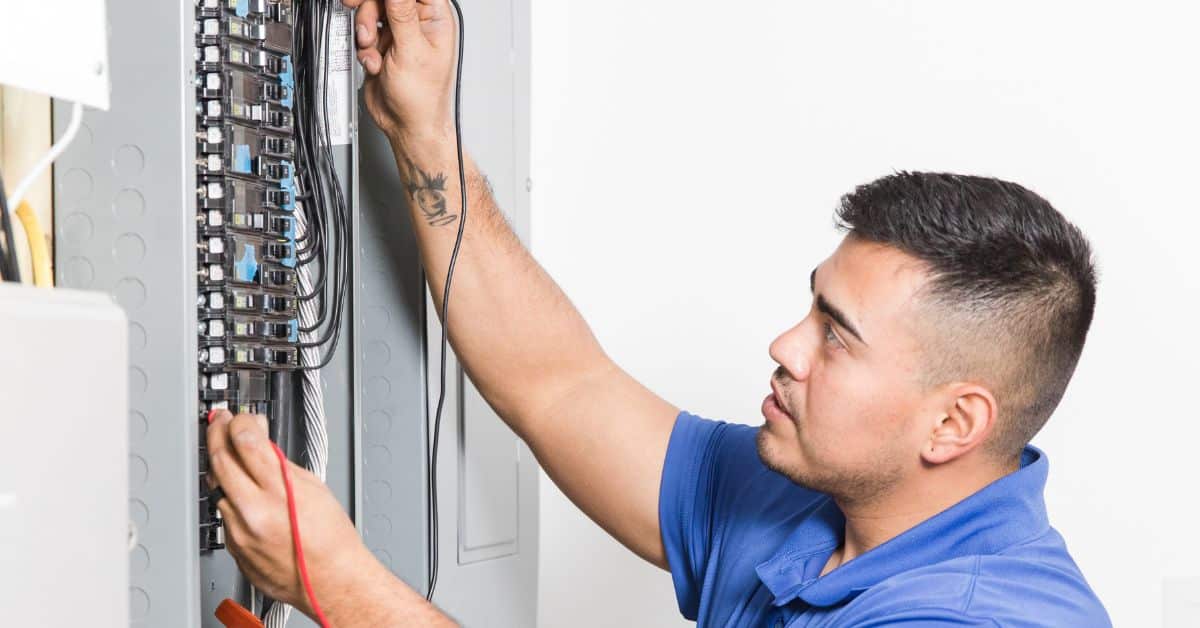 Electrician repairing a residential service panel
