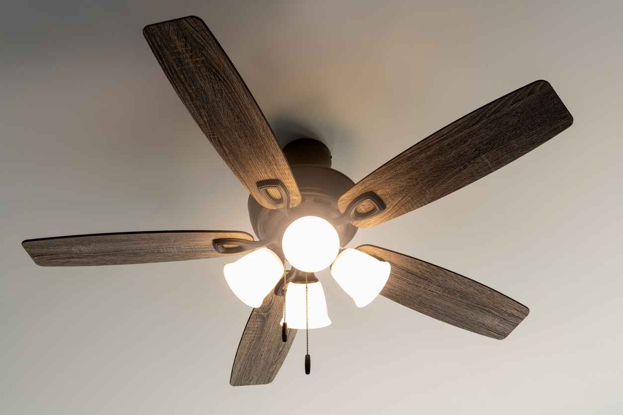 Residential ceiling fan in motion on a white ceiling.
