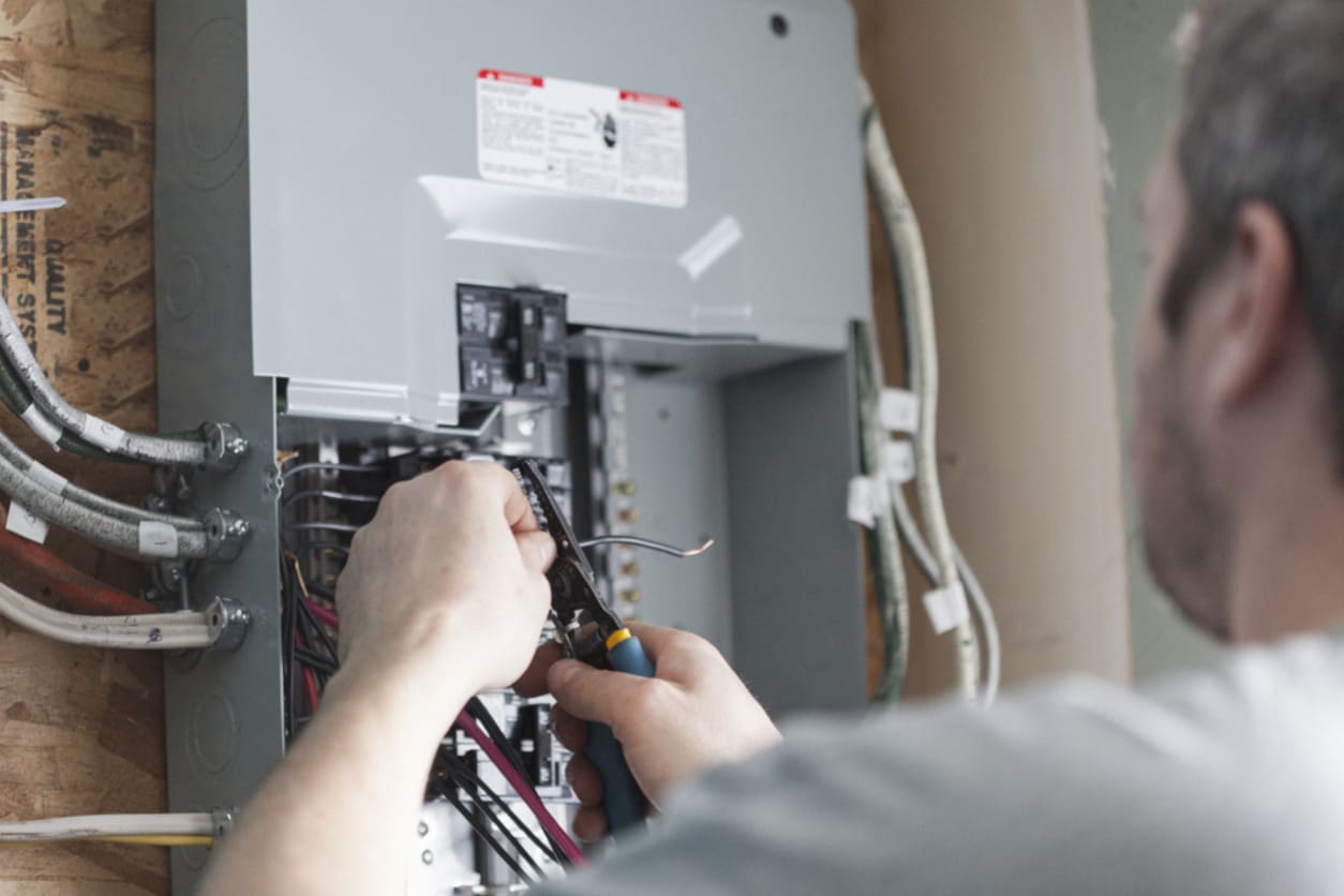 Electrician Working on Panel