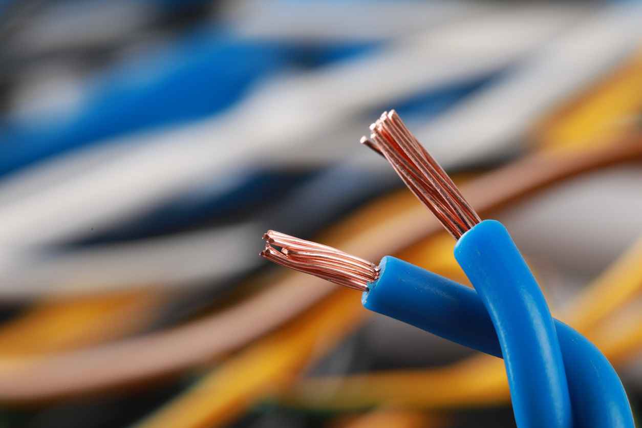 Light blue electrical wire on blurred background, closeup.