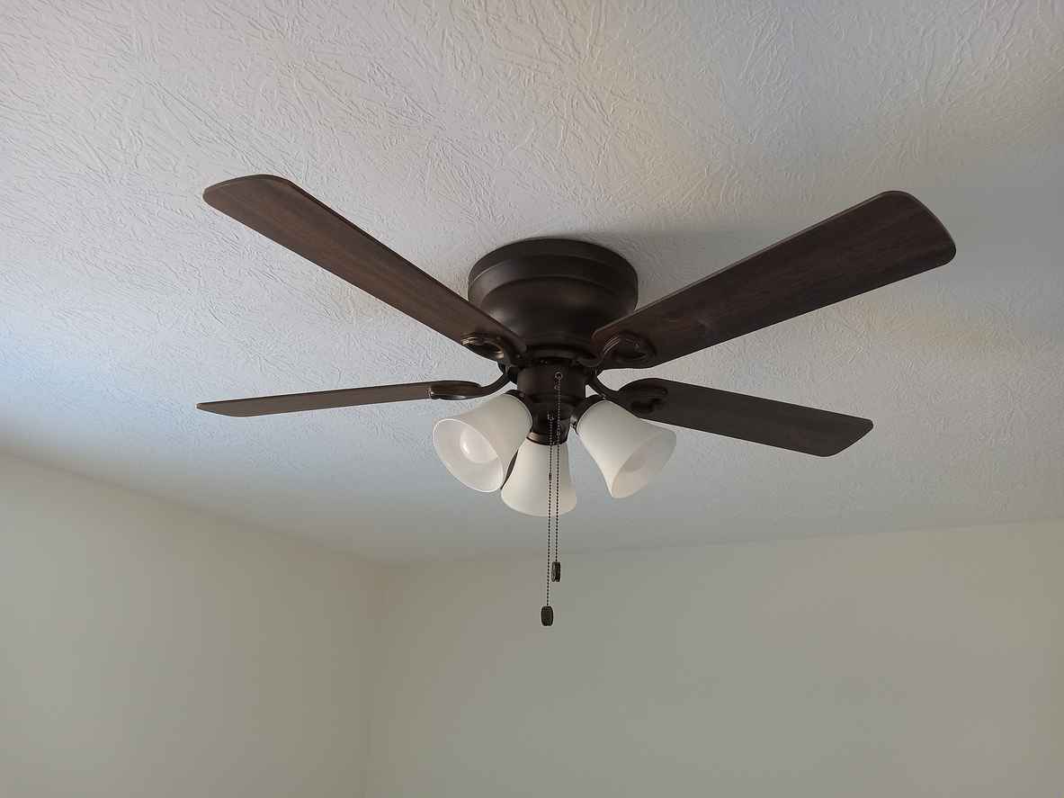 Brown ceiling fan with lights in a residential home