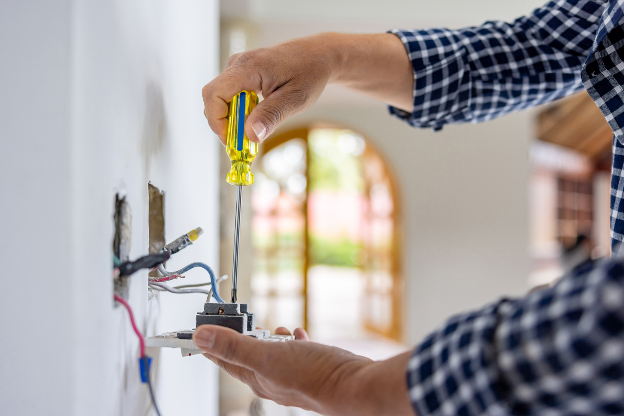 Electrician installing outlet