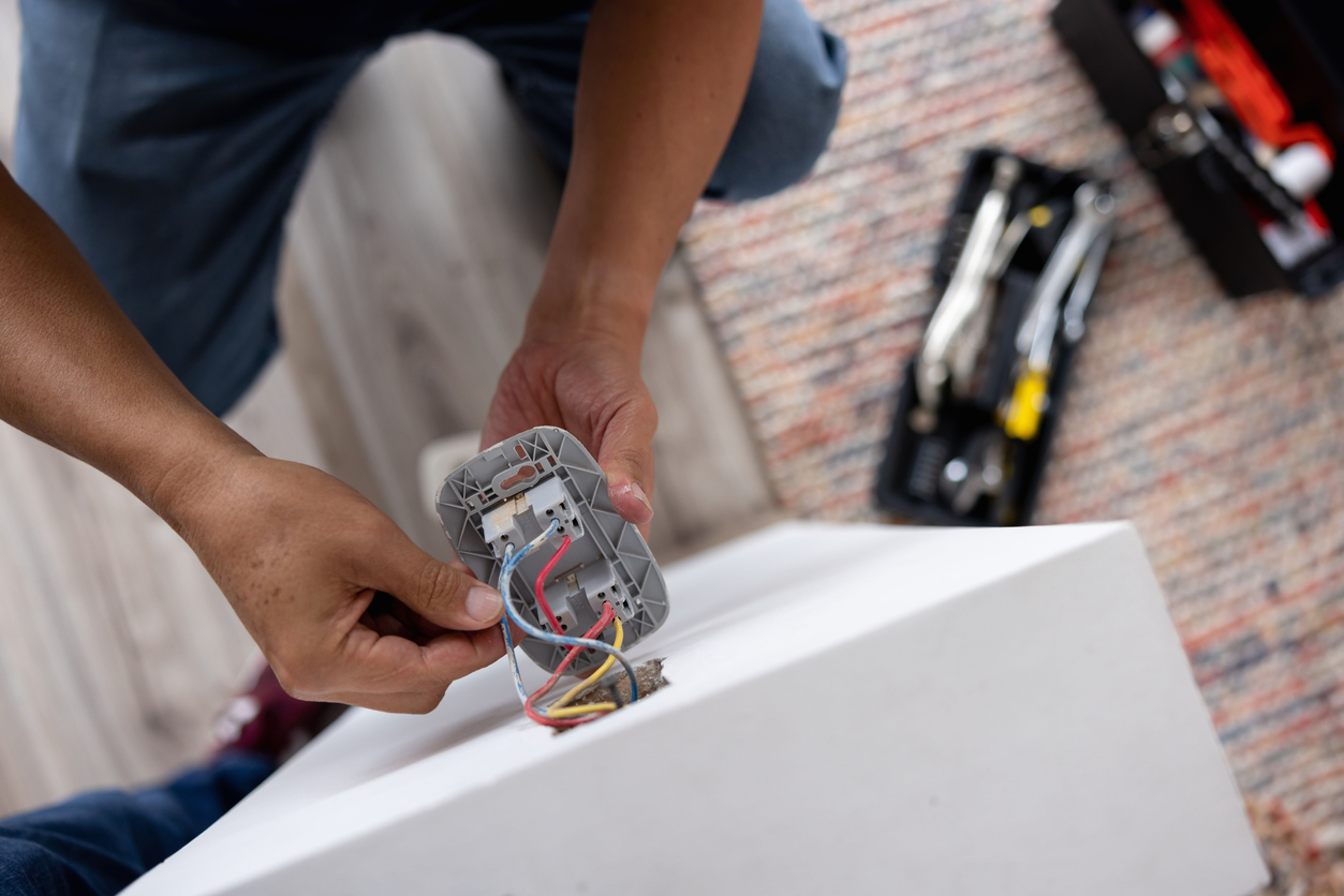 Electrician fixing an electrical outlet