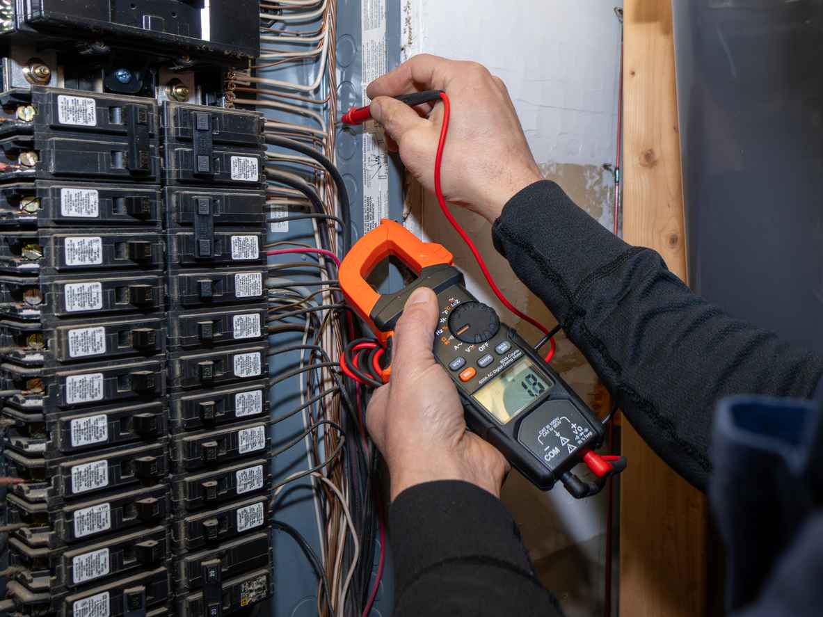 Home inspector testing home circuit breaker.