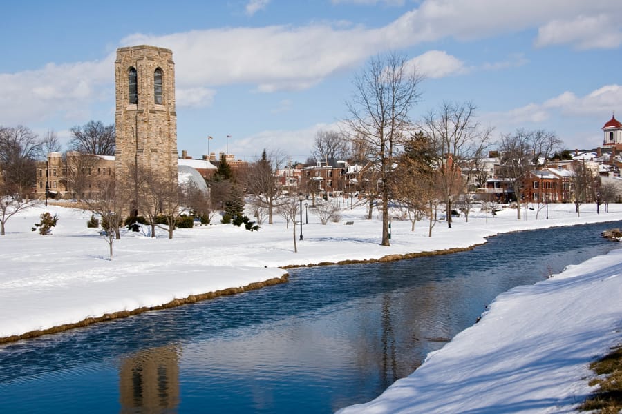 The bell tower in Frederick Maryland reflecting in a stream after a heavy snowfall.