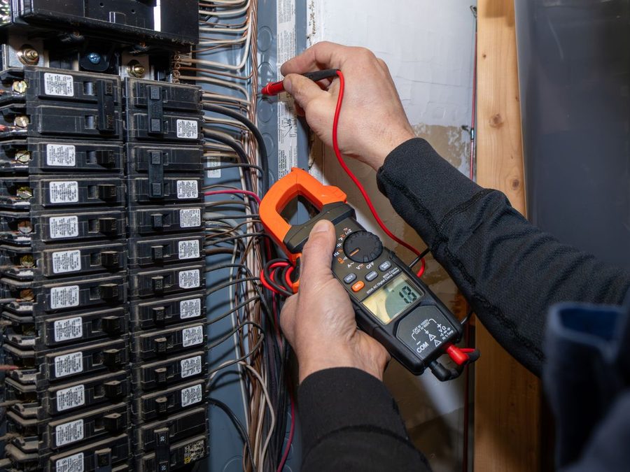 Electrician testing an electrical panel