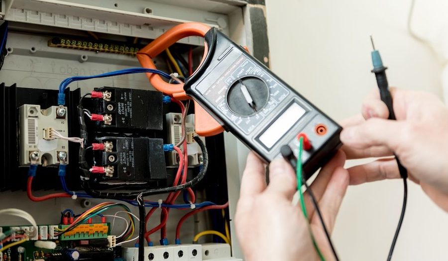 Electrician handling a whole home surge protection device