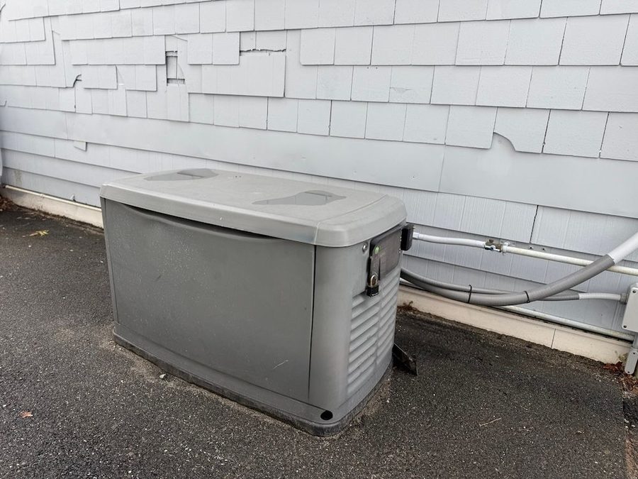 Generator connected to power on the side of a house